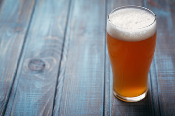 Pale ale on blue wood