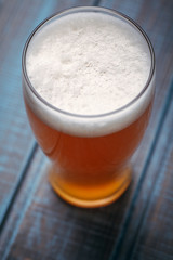 Pale ale on blue wood