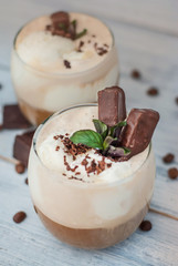Iced Mocha Coffee with Whip Cream, Summer Drinking times. Coffee Beans. rustic textured Wooden Background. Mint Leaves