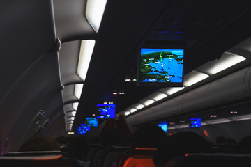 Salon of a modern airliner during a night flight. 