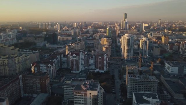 Sunset in megapolis. Video. Beautiful cityscape with top view on skyscrapers. Top view of the modern city at sunset