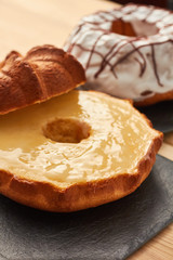 Close-up shot of a marble cake  with vanilla  glaze. Homemade, sugar free, wholegrain, walnut and pistachio. Vanilla icing.