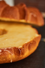 Close-up shot of a marble cake  with vanilla  glaze. Homemade, sugar free, wholegrain, walnut and pistachio. Vanilla icing.