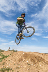 Fototapeta na wymiar Young man flying on dirtjump bike