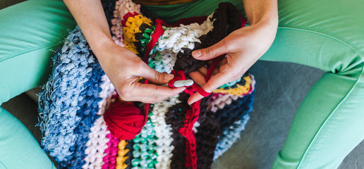 The woman is crocheting.
