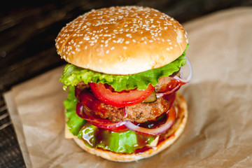 Delicious fresh homemade burger on a wooden table