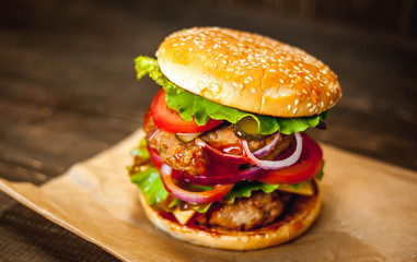 Delicious fresh homemade burger on a wooden table