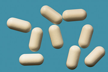 Pills is macro on a blue background on top