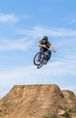 Young man flying on dirtjump bike