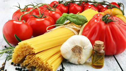 Italian food background with pasta, basil and tomato, health or vegetarian concept.