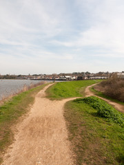 Fototapeta premium long walkway trail at side of bay of water uk manningtree nature background