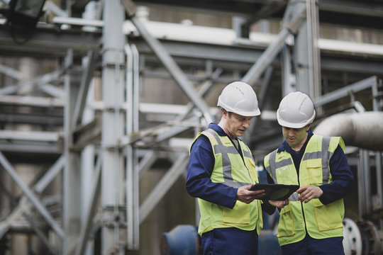 Industrial workers using a digital tablet on site