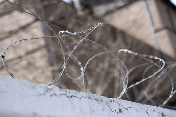 Concrete wall, against the backdrop of barbed wire, the concept of prison, salvation, Refugee, lonely.