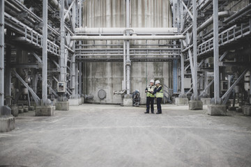 Industrial workers using a digital tablet on site