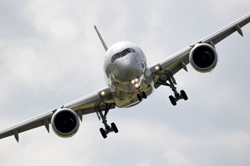 Flying passenger plane front