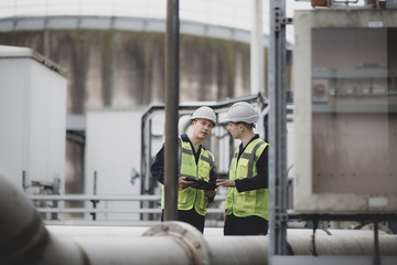 Industrial workers using a digital tablet on site