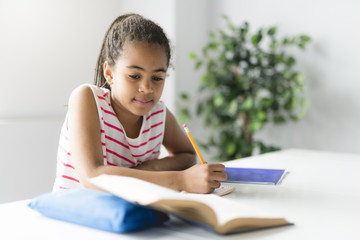 Black girl doing homework at home