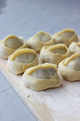 Fototapeta na wymiar Dumplings of thin dough stuffed