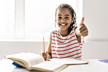 Black girl doing homework at home