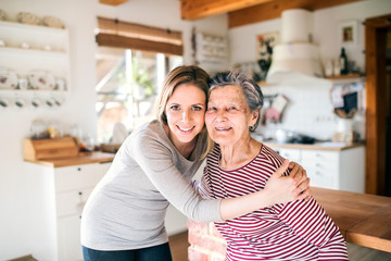 An elderly grandmother with an adult granddaughter at home.