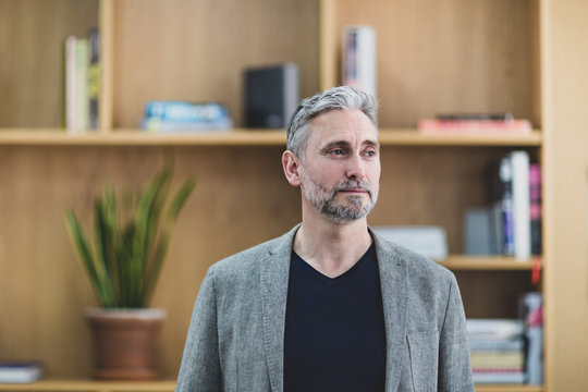 Businessman looking out window thinking