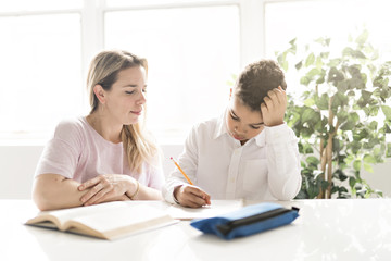 Obraz premium mother help Black boy doing homework at home