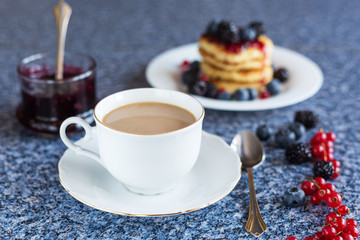 coffee with milk, .pancakes from cottage cheese with berries, and jam