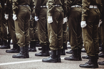 military men in green dress uniform stand at attention