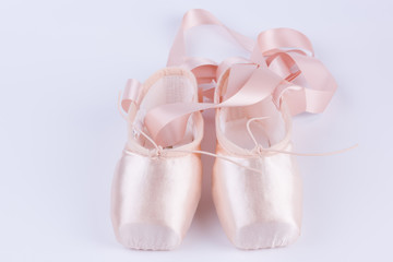 Fototapeta na wymiar Pink ballet shoes isolated on a white background