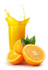 Glass of orange juice and oranges with leaves