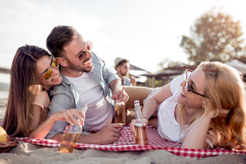 Group of friends enjoying summer vacation on a beach