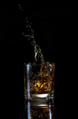 High splash in glass of whiskey