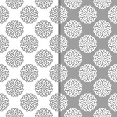 White and gray floral ornamental designs. Set of seamless patterns