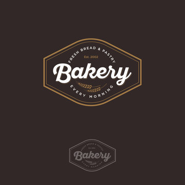 The bakery logo with spikelet. Bread and baking emblem. Vintage bakery logo. Gold and white inscription on a dark background.