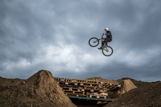 Young Man Jumping Over Hole In Dirtjump Circuit