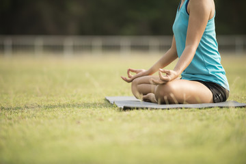 close up on hand sian woman yoga relax in the park