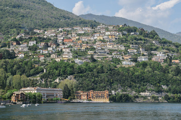 Panoramic view of quaint traditional waterfront houses on majestic Lake Como, Lombardy, Italy.