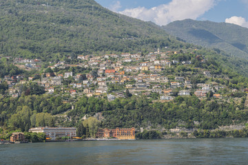 Fototapeta na wymiar Panoramic view of quaint traditional waterfront houses on majestic Lake Como, Lombardy, Italy.
