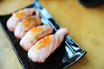 Grilled Salmon sushi on wood background