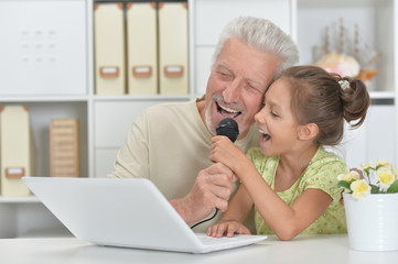 girl and grandfather with a laptop