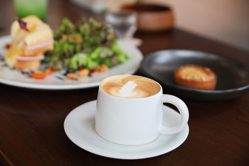 cappuccino or Latte art coffee made from milk on the wood table in coffee shop