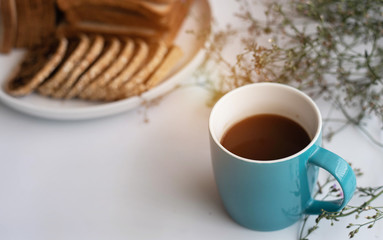 The black coffee in blue ceramic coffee cup,blurry light design background.