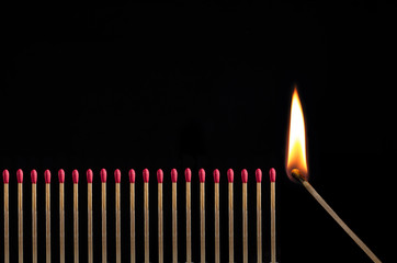 Row of matchsticks, one is igniting them