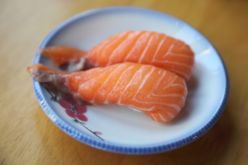 Salmon sushi on wood background