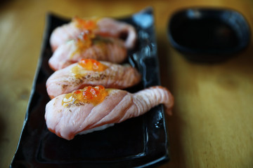 Grilled Salmon sushi on wood background