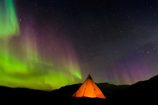 Lit up tent, Aurora Borealis in background, Narsaq, Vestgronland, Greenland