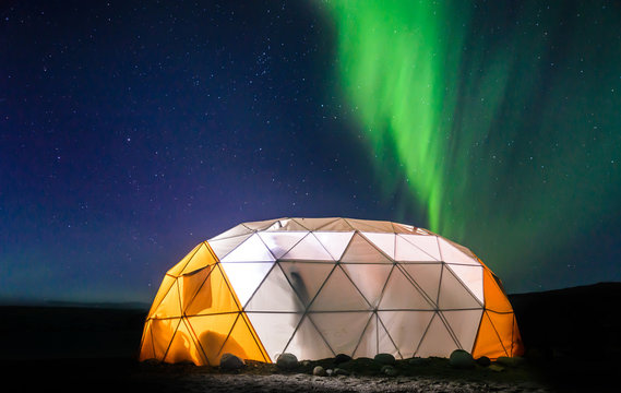 Lit up dome tent, Aurora Borealis in background, Narsaq, Vestgronland, Greenland