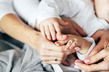Young family hands touching each other. Mother, father and child.