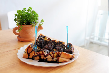 Chocolate toast bread on wood table with small houseplant, Sweet homemade dessert with clearly bright light background.