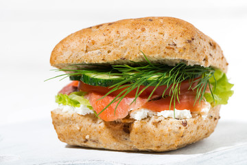 sandwich with salted fish and cream cheese on white wooden board, closeup